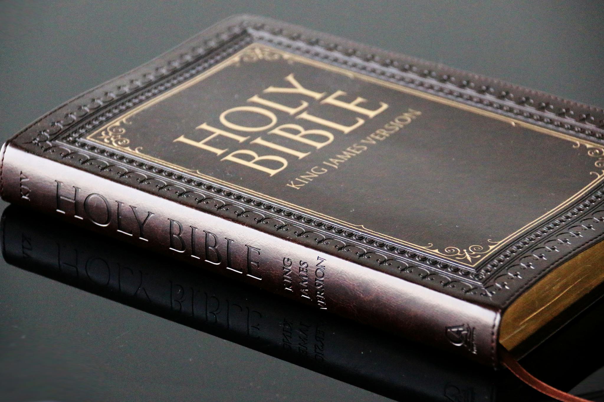 Open Bible with cross necklace